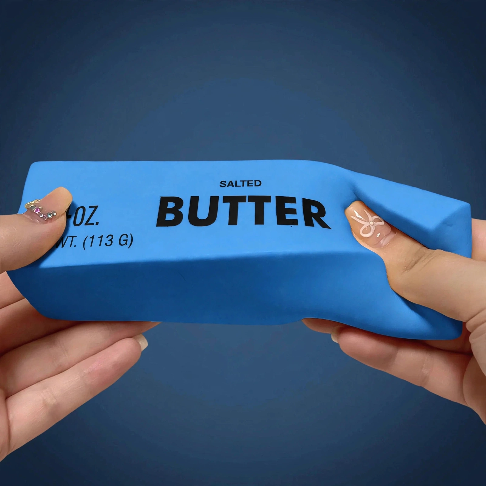 Hands squeezing the blue butter squishy 4oz soft foam